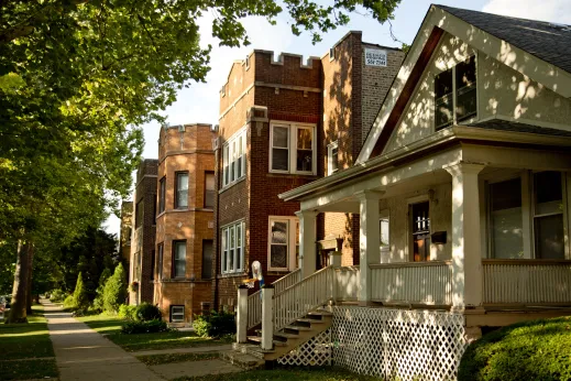 Single family home and front porch with apartments in the background in Arcadia Terrace