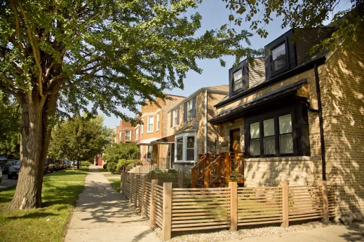 Single family home with wooden fence in front in Mayfair Chicago