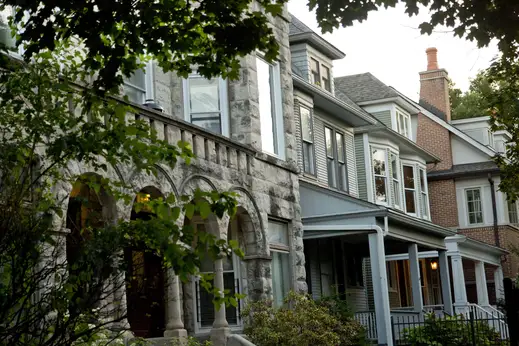 Stone masonry facade and front porches on single family homes in Graceland West