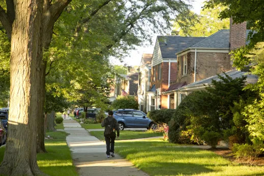 Student walking down sidewalk in Edgebrook neighborhood Chicago