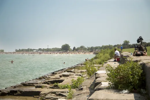Swimmers on beach and rocks on Lake Michigan in Margate Park Chicago