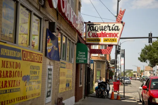 Taqueria sign and sidewalk in Little Village