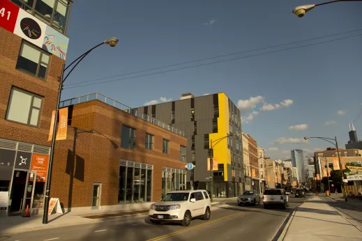 Traffic and modern apartment exteriors on N Milwaukee Ave in River West Chicago