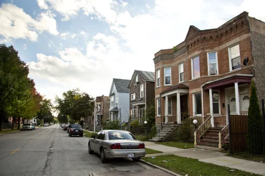 Two flat apartments and single family homes on neighborhood street in Fuller Park Chicago