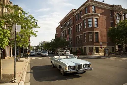 Vintage convertible car driving down street in Lakeview Chicago