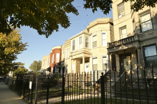 Vintage greystone apartments on neighborhood street in Washington Park Chicago