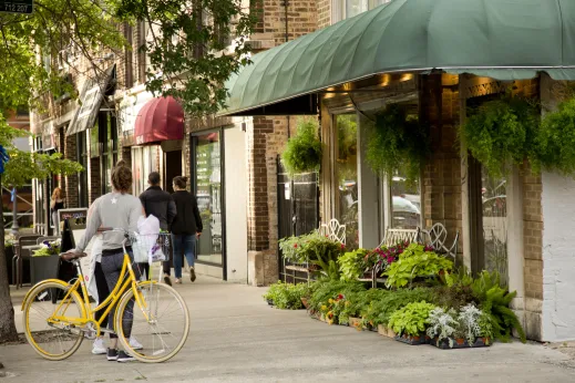 Yellow bicycle parked by garden shop entrance in Old Town Chicago