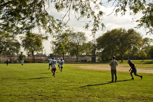 Youth football practice at public park near apartments in Fuller Park Chicago