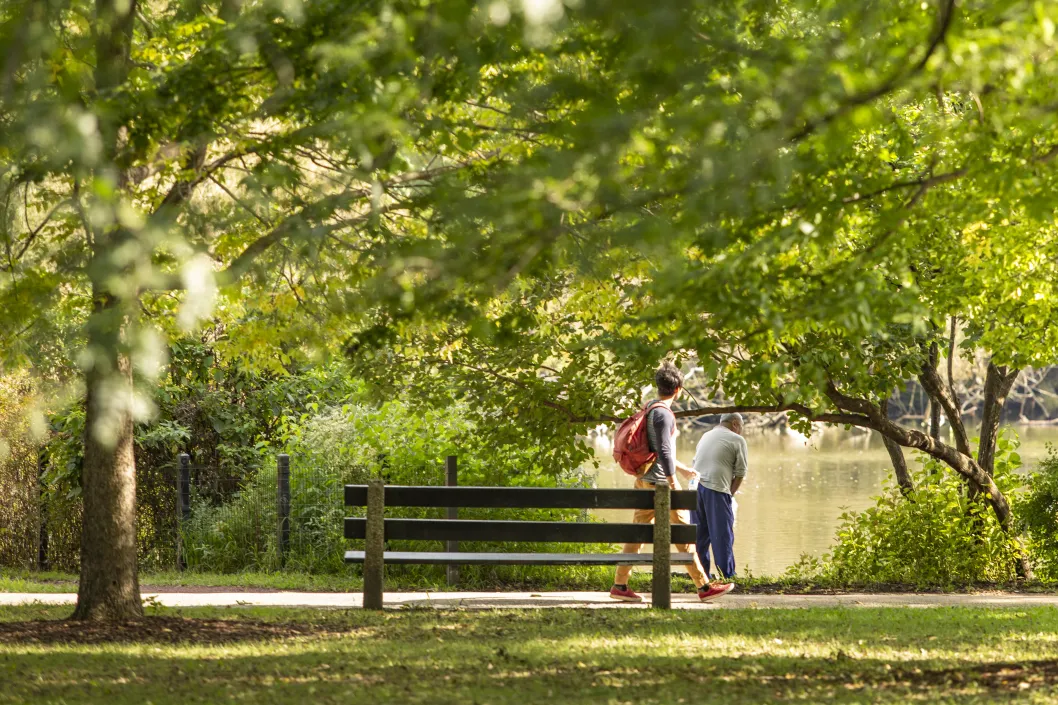 man walking on trail by public bench in Back of the Yards Chicago