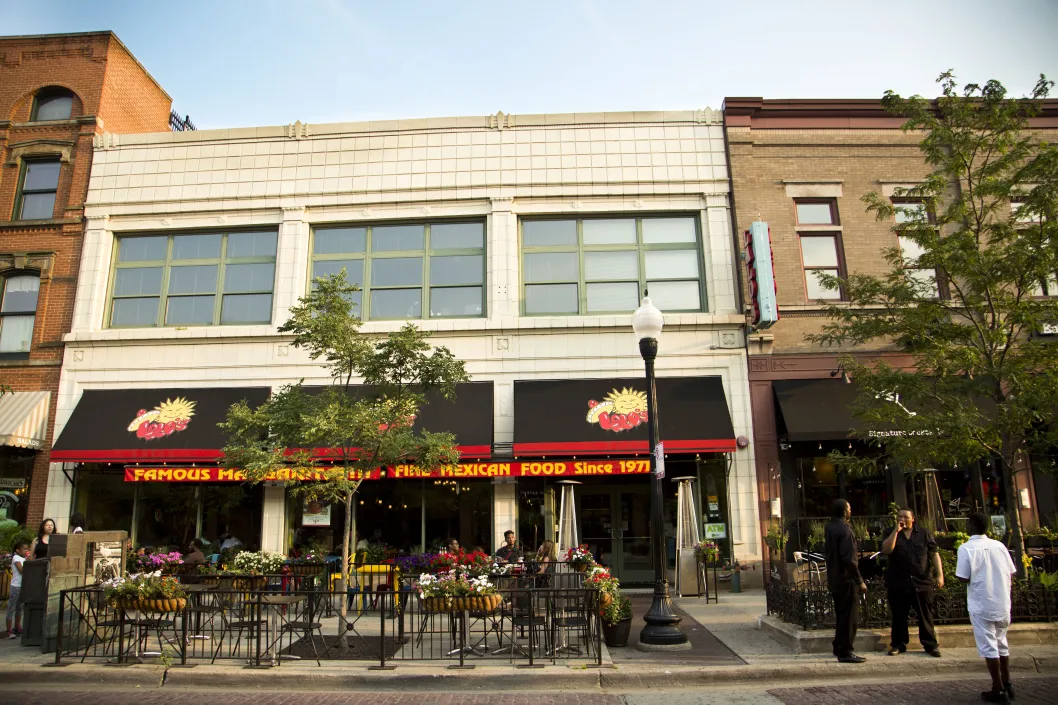 Mexican restaurant front entrance and patio seating on sidewalk in University Village