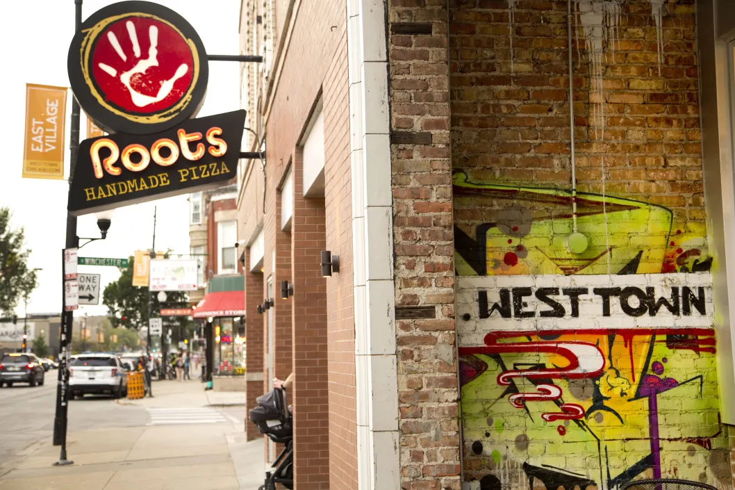 Roots Handmade Pizza restaurant sign and front entrance on W Chicago Ave in East Village