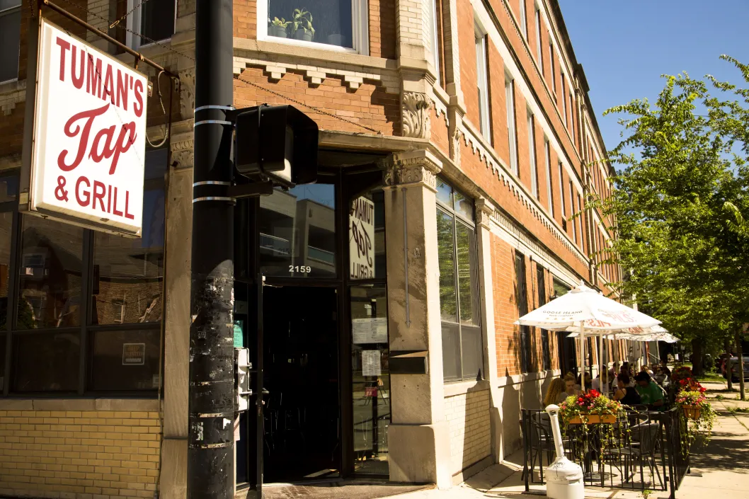 Tuman's Tap and neighborhood pub sign and front entrance with outdoor seating in Ukrainian Village