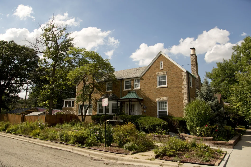 Brick single family home on corner lot with front door garden in Peterson Woods