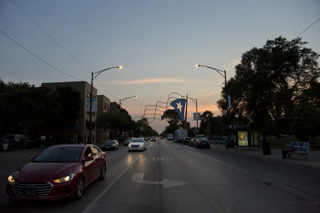 Cars on W Division St at dusk in Humboldt Park Chicago