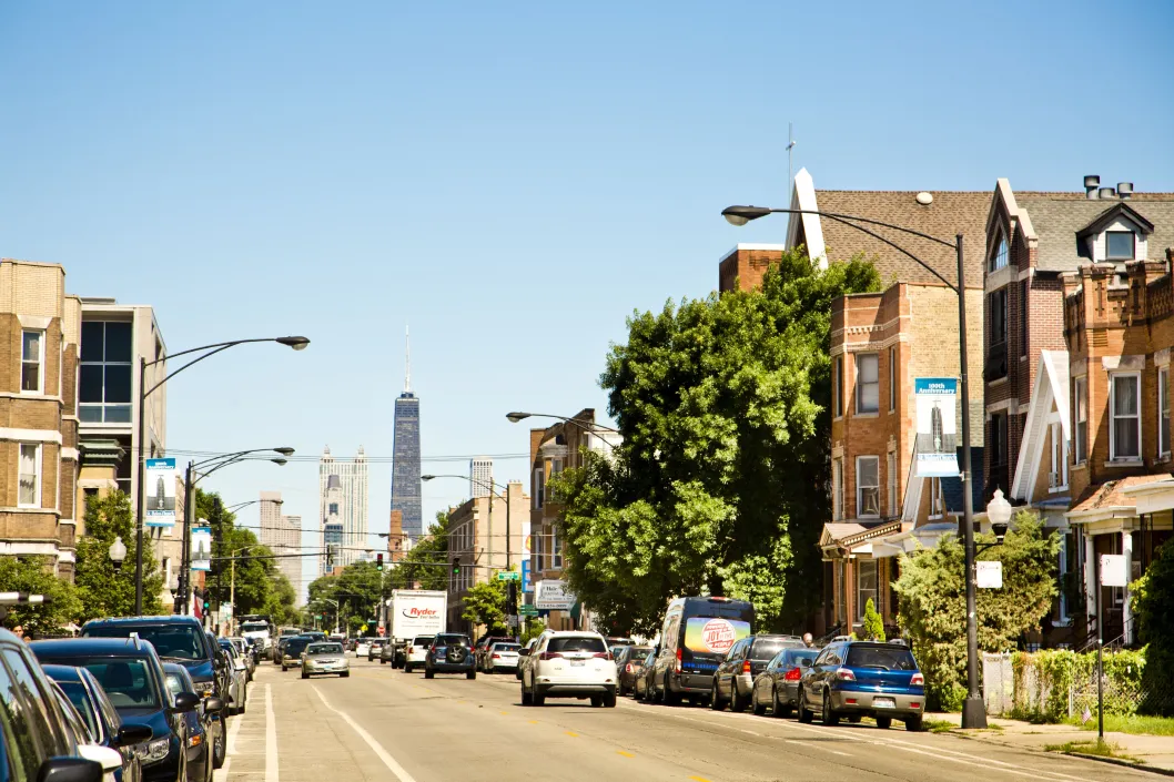 Cars and traffic on W Augusta Blvd with 875 N Michigan in the background in Ukrainian Village