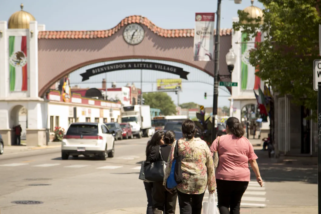 Pedestrians crossing North Troy Street in Little Village Chicago