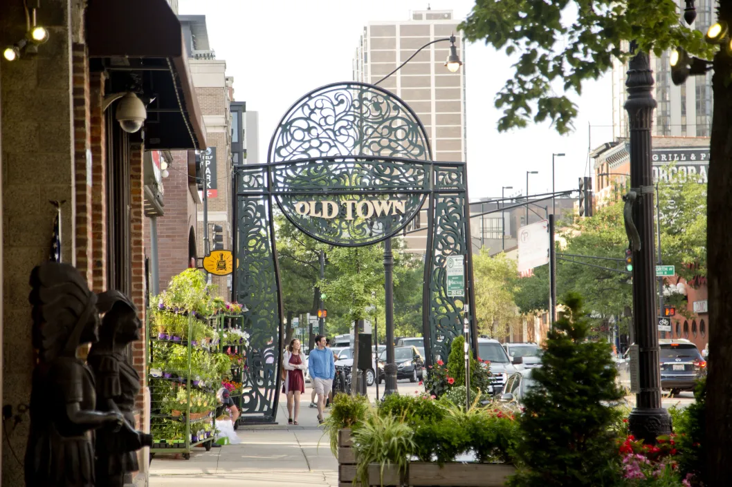 Pedestrians walking on North Wells Street with Old Town street sign