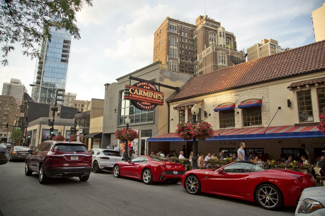 Red sports cars parked outside Carmines Restaurant in the Gold Coast Chicago