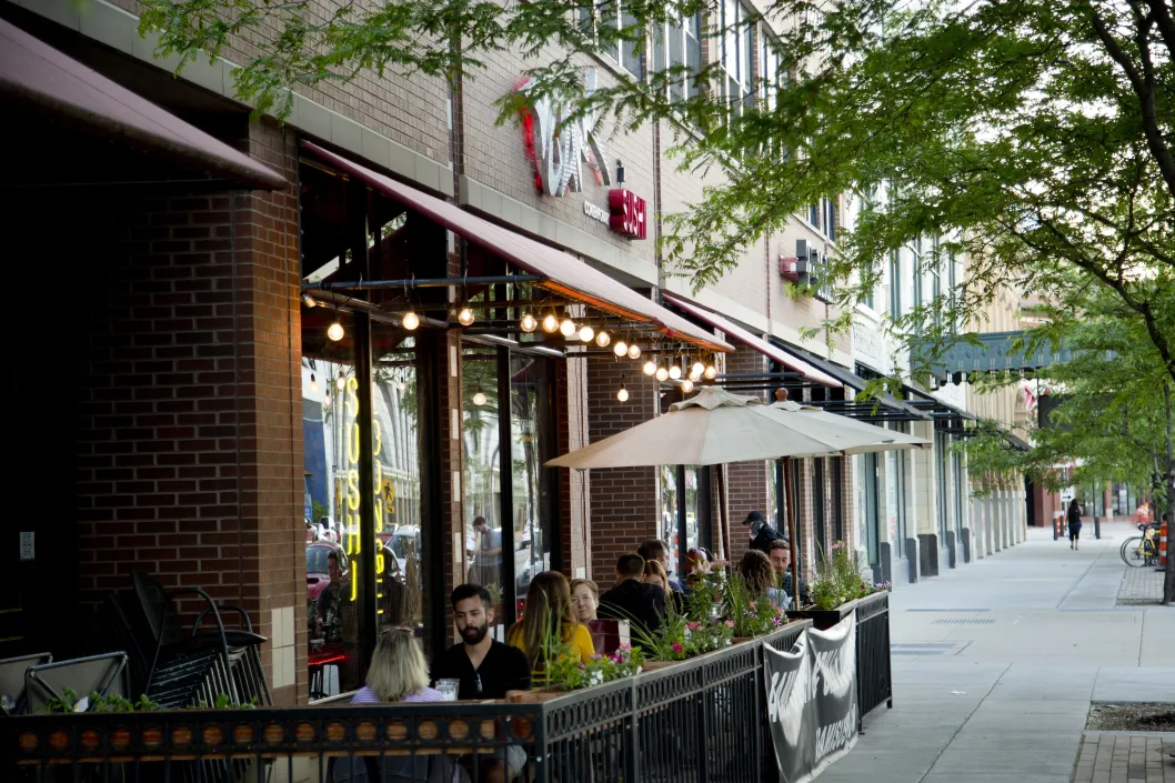 Restaurant with outdoor seating patio and diners on sidewalk in Uptown Chicago