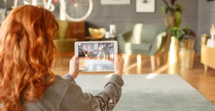 woman holding tablet taking photo of apartment interior_resized